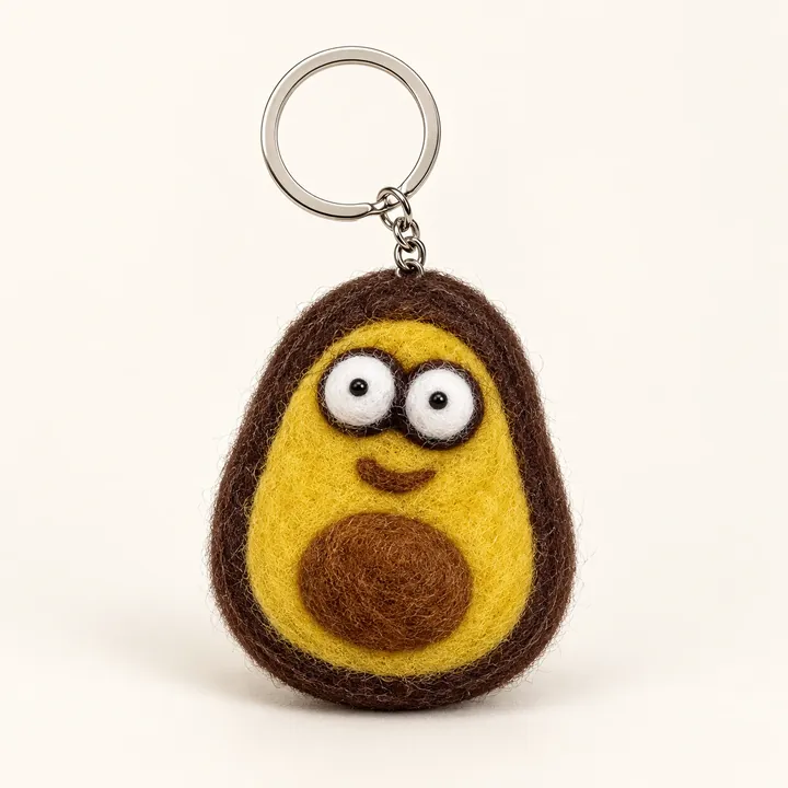 AI studio recreation: Avocado keychain in handmade wool felt on a warm ivory background
