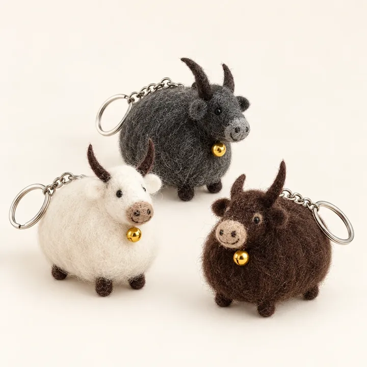 AI studio recreation: Himalayan yak keychains in handmade wool felt on a warm ivory background